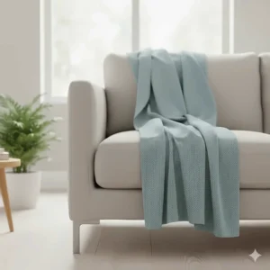 A lightweight 100% cotton breathable throw in duck egg blue, perfect for a UK summer lounge.