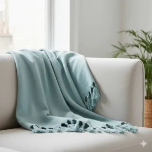 A premium duck egg blue luxury throw blanket with elegant tasselled edges.