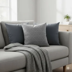 A coordinated look featuring a grey throw for a sofa paired with matching slate grey scatter cushions.