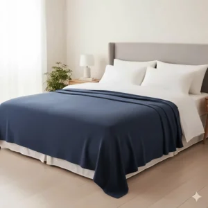 A king-size navy blanket spread fully across a bed to show its generous dimensions and drape.
