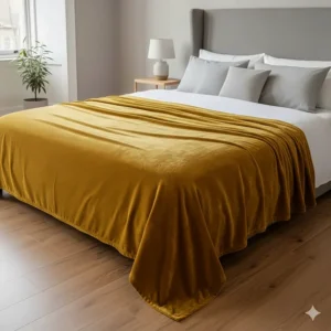 An extra-large velvet throw blanket covering a king-size bed, showing its generous dimensions.