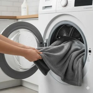 A durable teddy fleece blanket being removed from a washing machine, highlighting easy care.