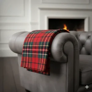 A traditional red tartan check wool-blend throw blanket, a classic British style for under £50.
