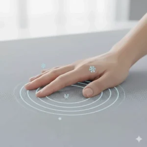 Close-up of a hand feeling the silky, cool-to-the-touch surface of a cooling blanket designed for hot sleepers.