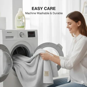 A cooling blanket being removed from a front-loading washing machine, highlighting easy care and durability.