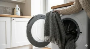 A long lasting blanket being removed from a washing machine, looking brand new after multiple cycles