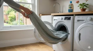 Illustration of a machine-washable all season blanket being removed from a front-loading washing machine.