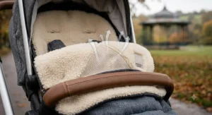Detailed 4K macro photograph showing the breathable mesh material and soft shearling lining of a matching pram footmuff, emphasizing air circulation.