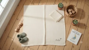 A vibrant stack of personalised nursery blankets neatly arranged on a wooden chest.