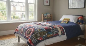 The superhero blanket is neatly folded on a light wood chest of drawers, wrapped in a paper band with a "To a Super Hero!" gift tag. Background shows Beano books and a Paddington Bear.
