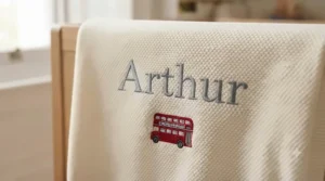 Close-up of delicate custom embroidery showing a personalised baby blanket with name in premium stitching.