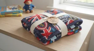 A clear view of the repeating comic-style panels on the superhero blanket, showcasing the Captain Britain shield, Big Ben skyline, and British-themed superhero text.