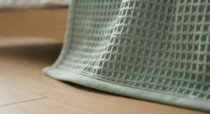 Detailed view of reinforced edge stitching and box quilting on a premium breathable cooling blanket.