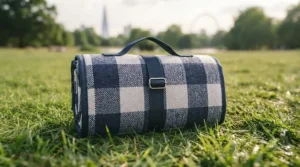 An extra large picnic blanket for groups folded compactly with a convenient carry strap for easy transport to festivals or parks.