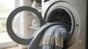 An all-season blanket being taken out of a modern washing machine, highlighting easy care and machine-washable convenience.