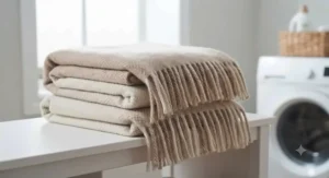 Freshly laundered, crease-free multi-season throw folded neatly in a utility space, highlighting its easy-care and machine-washable properties.
