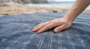 Close-up of a soft fleece top layer on a picnic rug providing comfort for lounging at the beach.