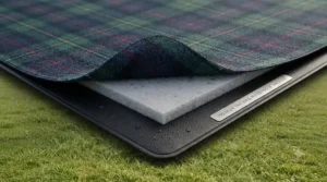 Cross-section diagram of a waterproof picnic blanket showing soft fleece top, foam padding, and PEVA damp-proof backing